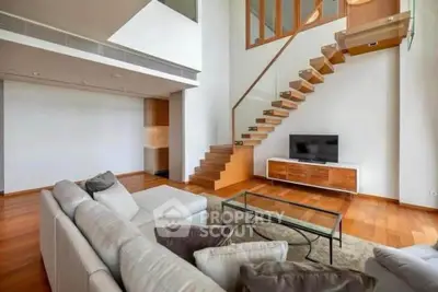 Modern living room with stylish staircase and cozy seating area