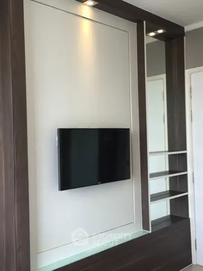 Modern living room with sleek TV wall mount and built-in shelving