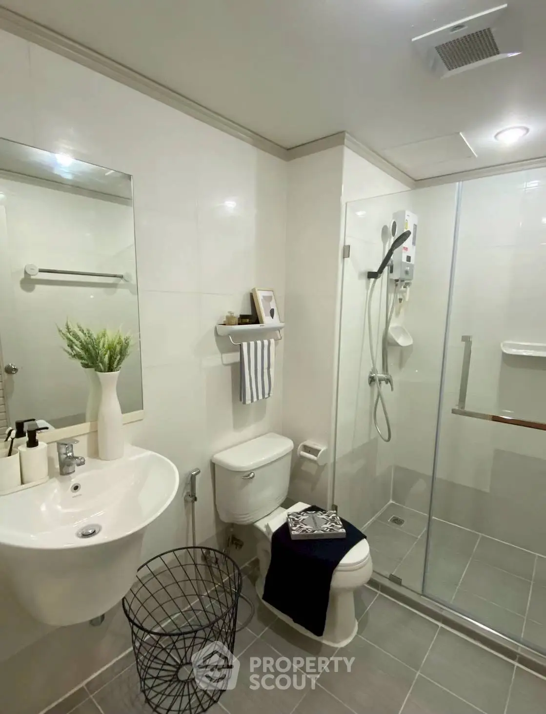 Modern bathroom with glass shower, sleek sink, and stylish decor