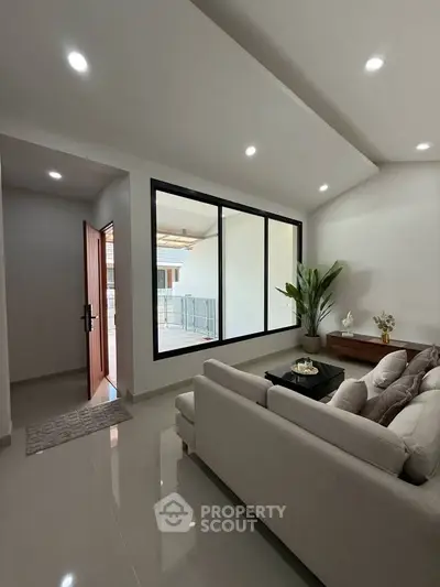 Modern living room with large window and elegant decor