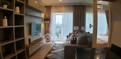 Modern living room with stylish decor and city view, featuring a cozy sofa and wall-mounted TV.