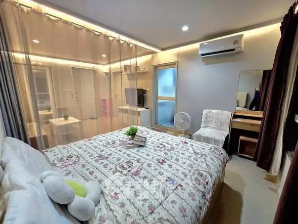 Cozy bedroom with elegant decor and modern amenities, featuring a comfortable bed and stylish lighting.