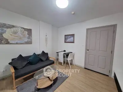 Modern living room with stylish furniture and decor, featuring a cozy sofa and elegant artwork.