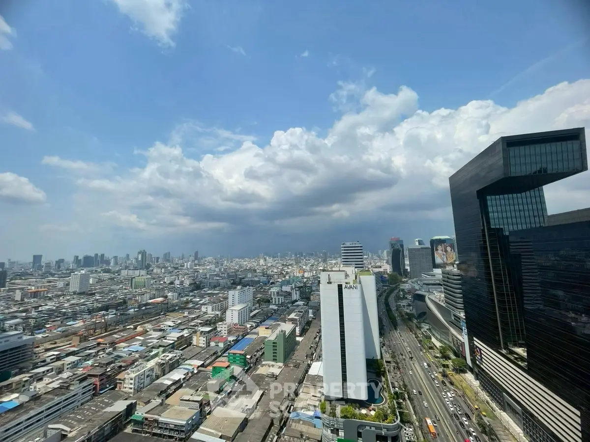 Stunning cityscape view from a high-rise building showcasing urban skyline and modern architecture.