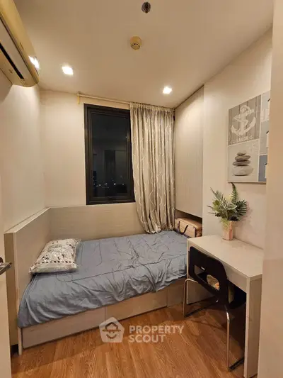 Cozy bedroom with modern decor and wooden flooring, perfect for a peaceful retreat.
