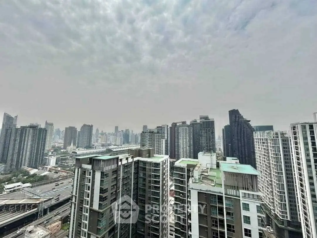 Stunning cityscape view from high-rise building balcony, showcasing urban skyline and modern architecture.