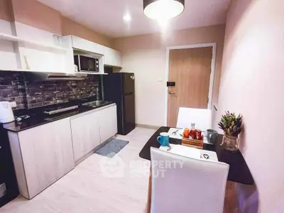 Modern kitchen with sleek design and dining area, featuring stylish appliances and cozy ambiance.