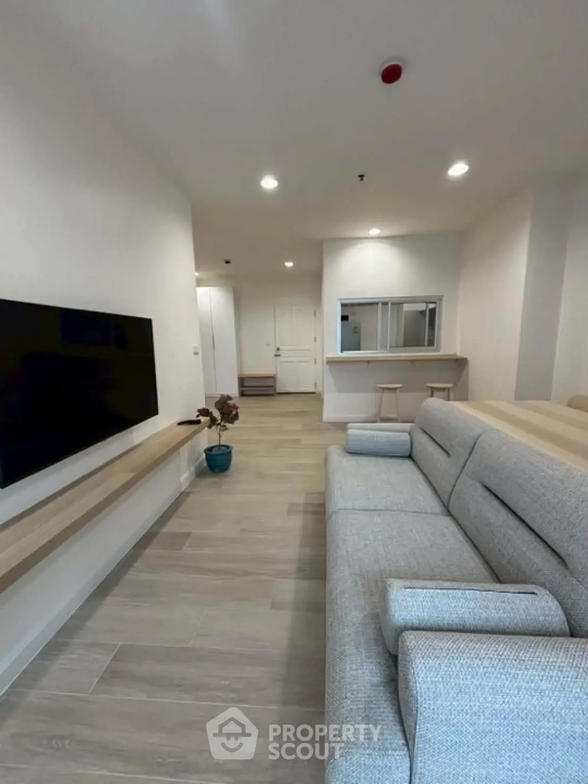 Modern living room with sleek design and large wall-mounted TV