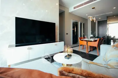 Luxurious modern living room with elegant decor and large flat-screen TV, perfect for stylish urban living.