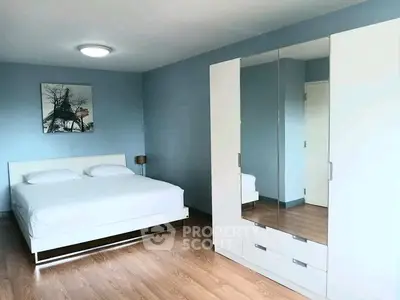 Spacious modern bedroom with sleek white furniture and elegant decor