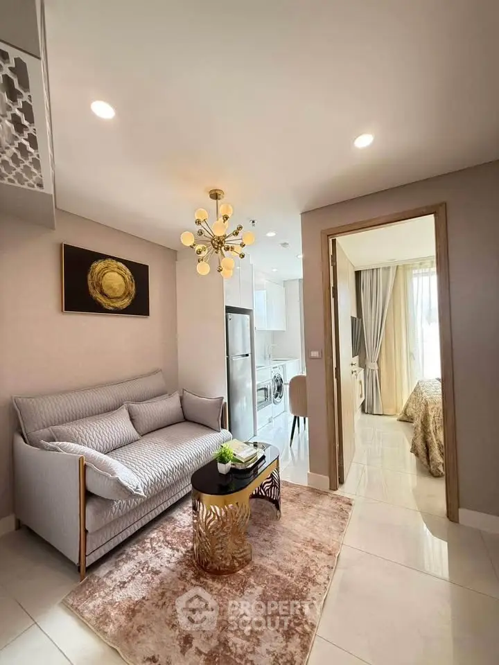 Modern living room with elegant decor and open view into a cozy bedroom