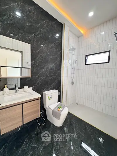 Luxurious modern bathroom with sleek black marble tiles and elegant fixtures
