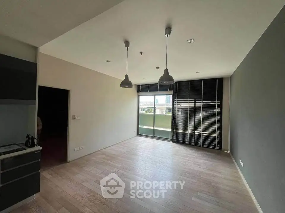Spacious modern living room with large windows and wooden flooring