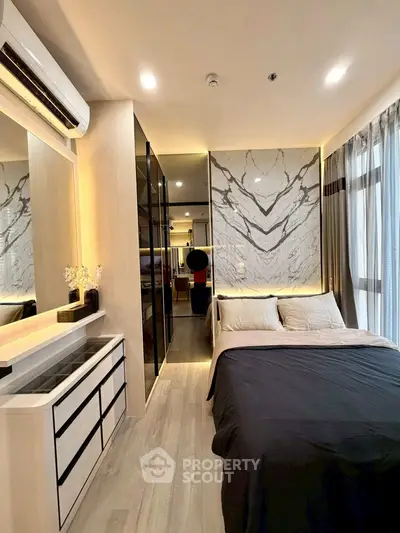 Modern bedroom with elegant marble accent wall and sleek built-in storage solutions.