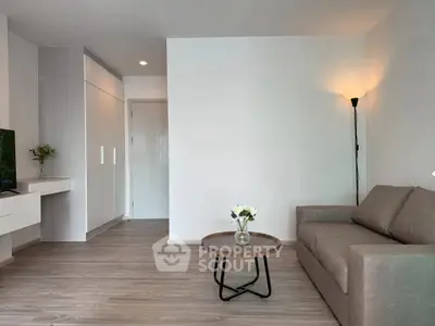 Modern living room with sleek design, featuring a cozy sofa, stylish coffee table, and elegant floor lamp.