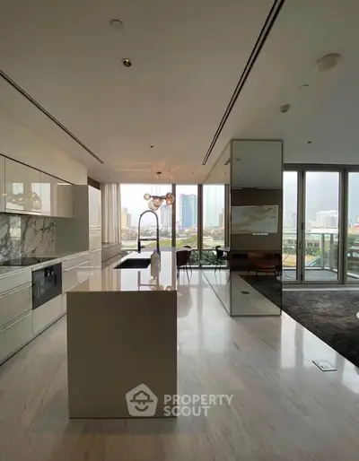 Luxurious modern kitchen with open layout and stunning city view, featuring sleek marble countertops and elegant lighting.