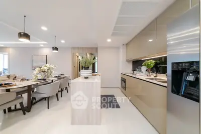 Modern open-layout kitchen and dining area with sleek design and elegant decor.
