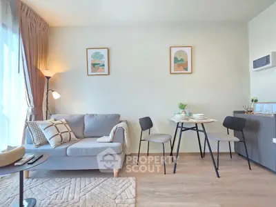 Modern living room with cozy sofa and dining area, bright and inviting space.