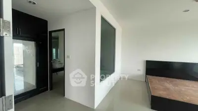Modern minimalist bedroom with large window and sleek design