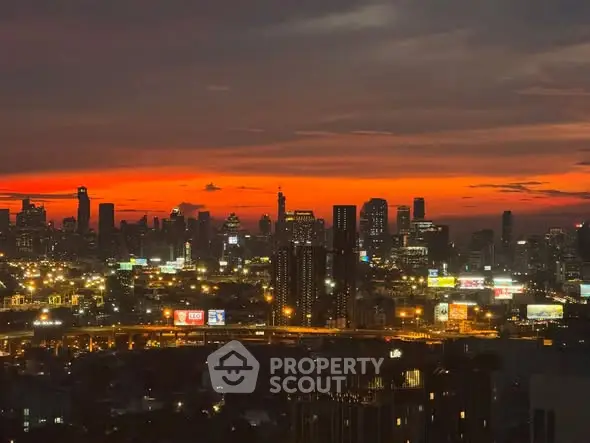 Stunning city skyline view at sunset with vibrant orange sky.