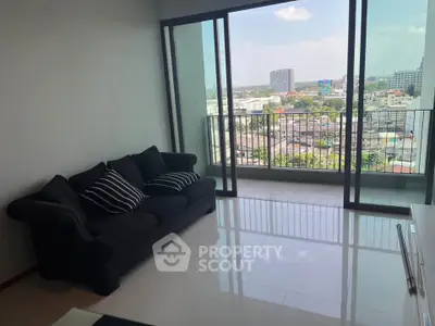 Spacious living room with stunning city view and large balcony access.