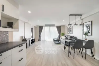 Spacious modern living room with open layout and elegant dining area, featuring stylish decor and ample natural light.