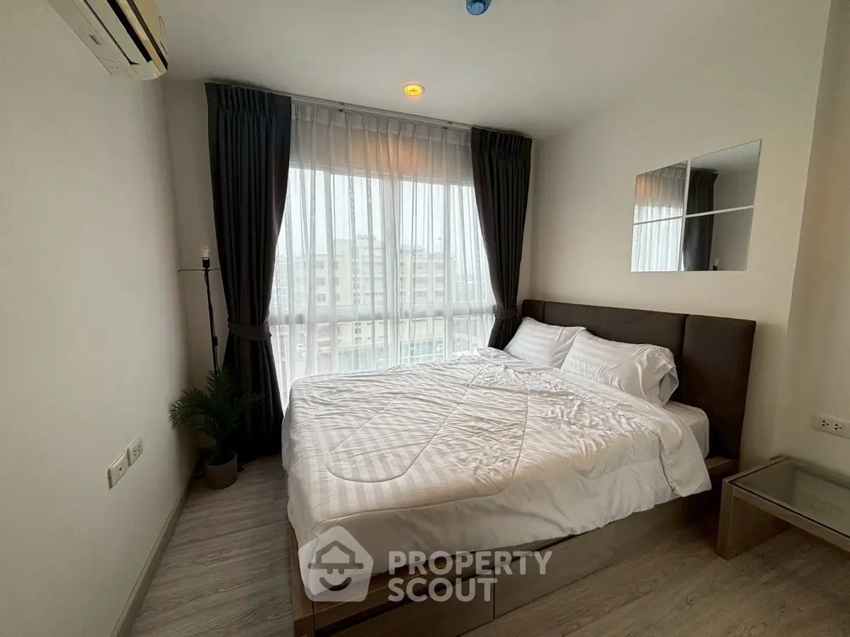 Cozy modern bedroom with large window and stylish decor