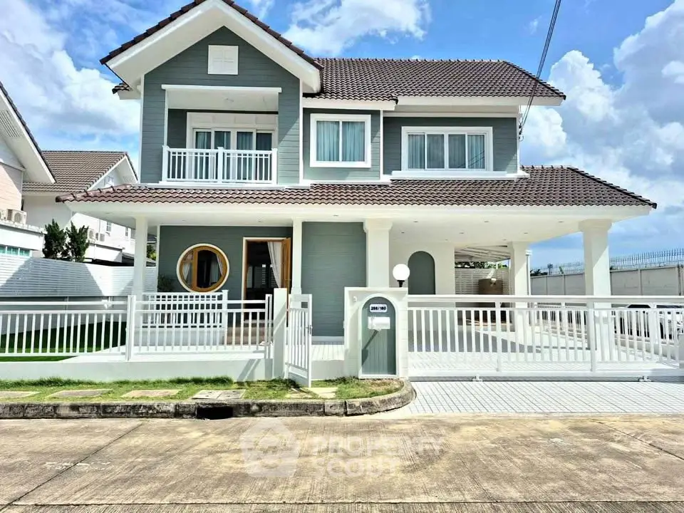 Charming two-story house with modern design and spacious driveway in a serene neighborhood.