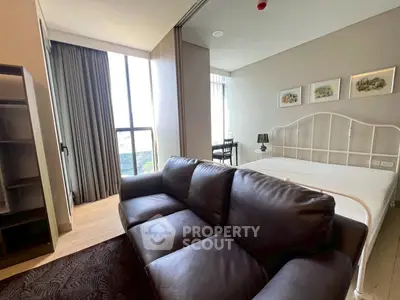Modern bedroom with large window and stylish decor in a high-rise apartment