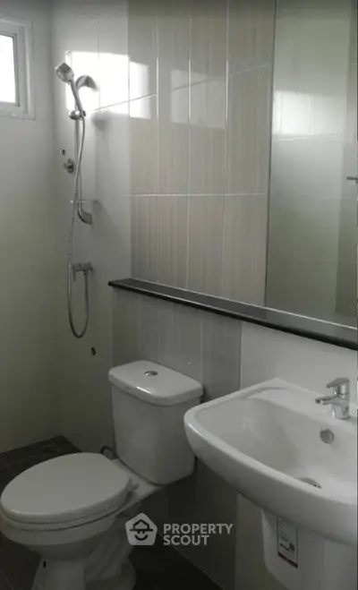 Modern bathroom with sleek fixtures and neutral tiles, perfect for a contemporary home.