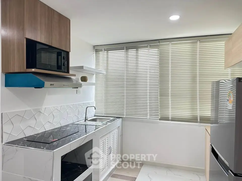 Modern kitchen with sleek design, featuring built-in appliances and stylish cabinetry.