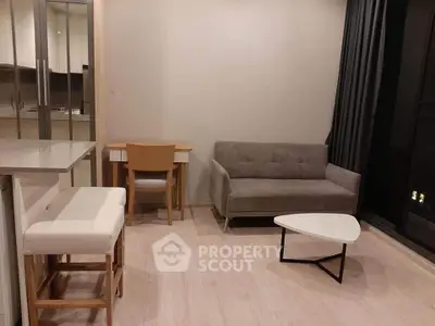 Modern living room with stylish furniture and neutral tones, featuring a cozy sofa and sleek coffee table.