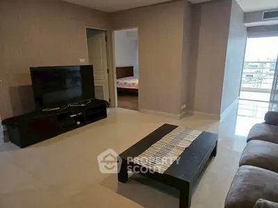 Spacious living room with modern decor and balcony access in a stylish apartment.