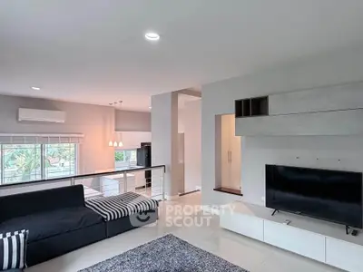 Spacious modern living room with open kitchen and sleek design