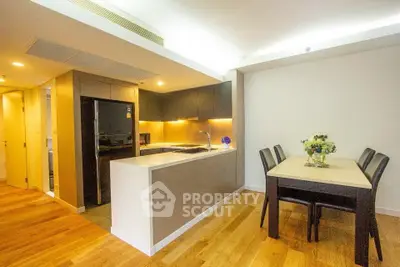 Modern kitchen and dining area with sleek design and wooden flooring