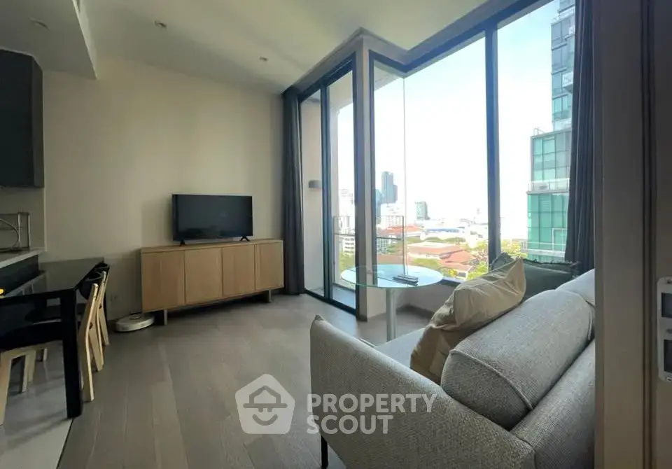 Modern living room with floor-to-ceiling windows and city view