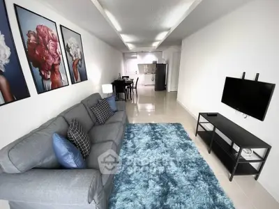 Modern living room with stylish decor and open kitchen layout in a bright apartment.