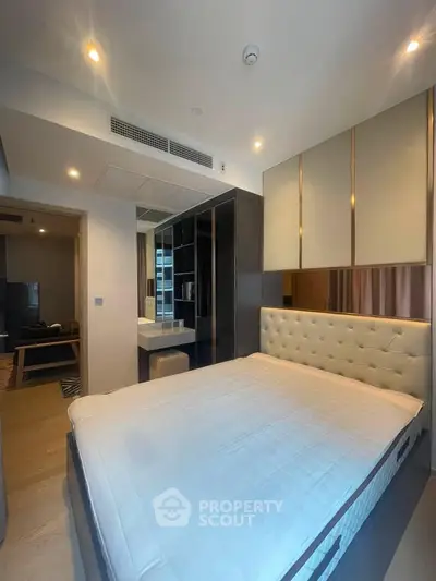 Modern bedroom with stylish decor and ample storage in a contemporary apartment.