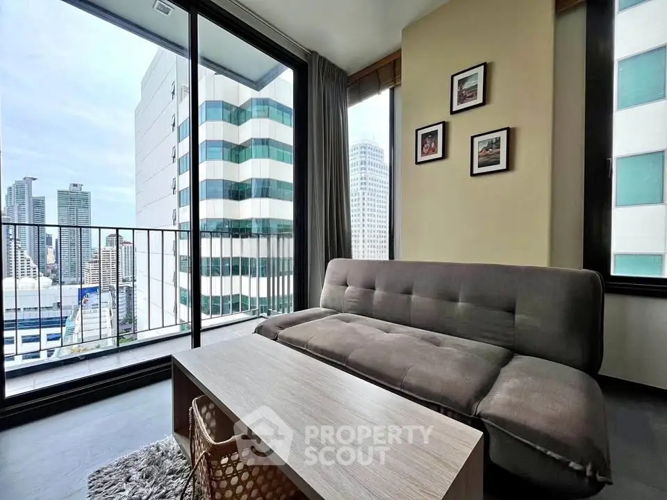 Modern living room with city view, featuring a sleek sofa and stylish decor in a high-rise apartment.