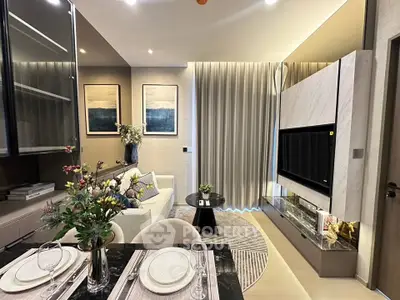 Modern living room with elegant decor, featuring a cozy sofa, stylish TV unit, and dining area with floral centerpiece.