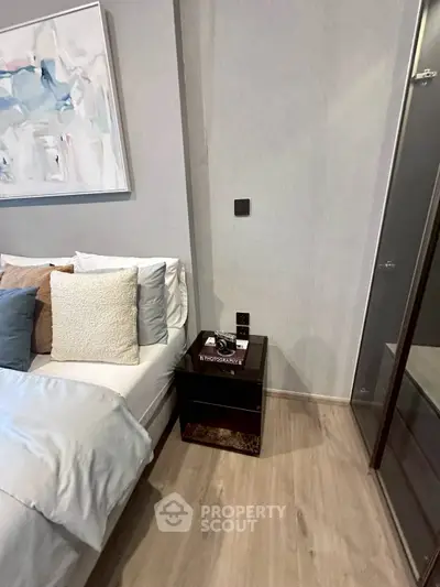 Modern bedroom with stylish decor and cozy bedding in a contemporary apartment.