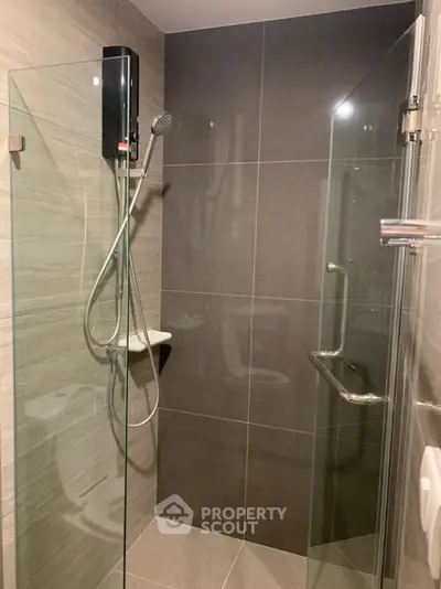 Modern bathroom with sleek glass shower enclosure and contemporary fixtures.