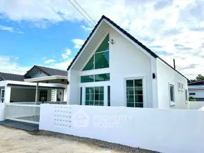 Charming modern white house with A-frame roof and spacious driveway