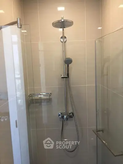 Modern bathroom shower with sleek chrome fixtures and glass enclosure