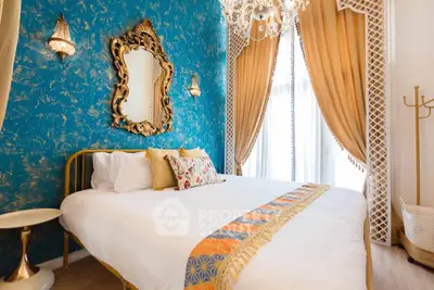 Luxurious bedroom with ornate decor and vibrant blue accent wall