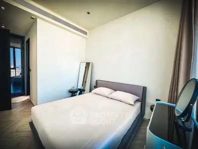 Modern bedroom with minimalist design and stylish furniture in a high-rise apartment.