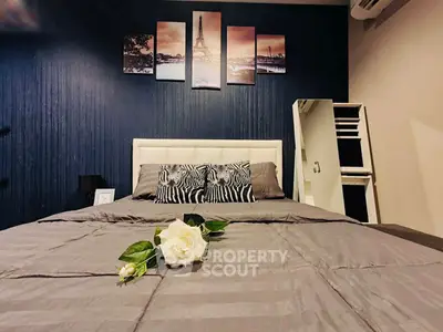 Stylish bedroom with modern decor and elegant wall art, featuring a cozy bed and chic furnishings.