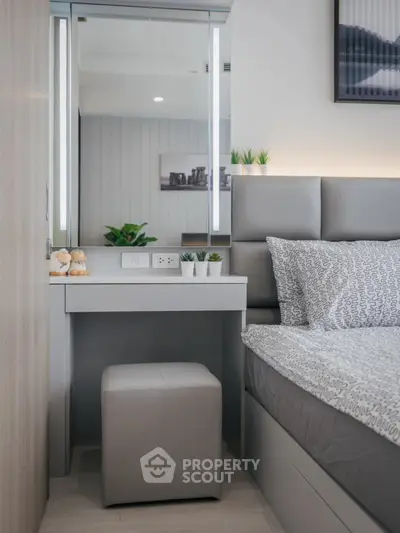 Modern bedroom with stylish decor and cozy ambiance, featuring a sleek vanity and comfortable bed.