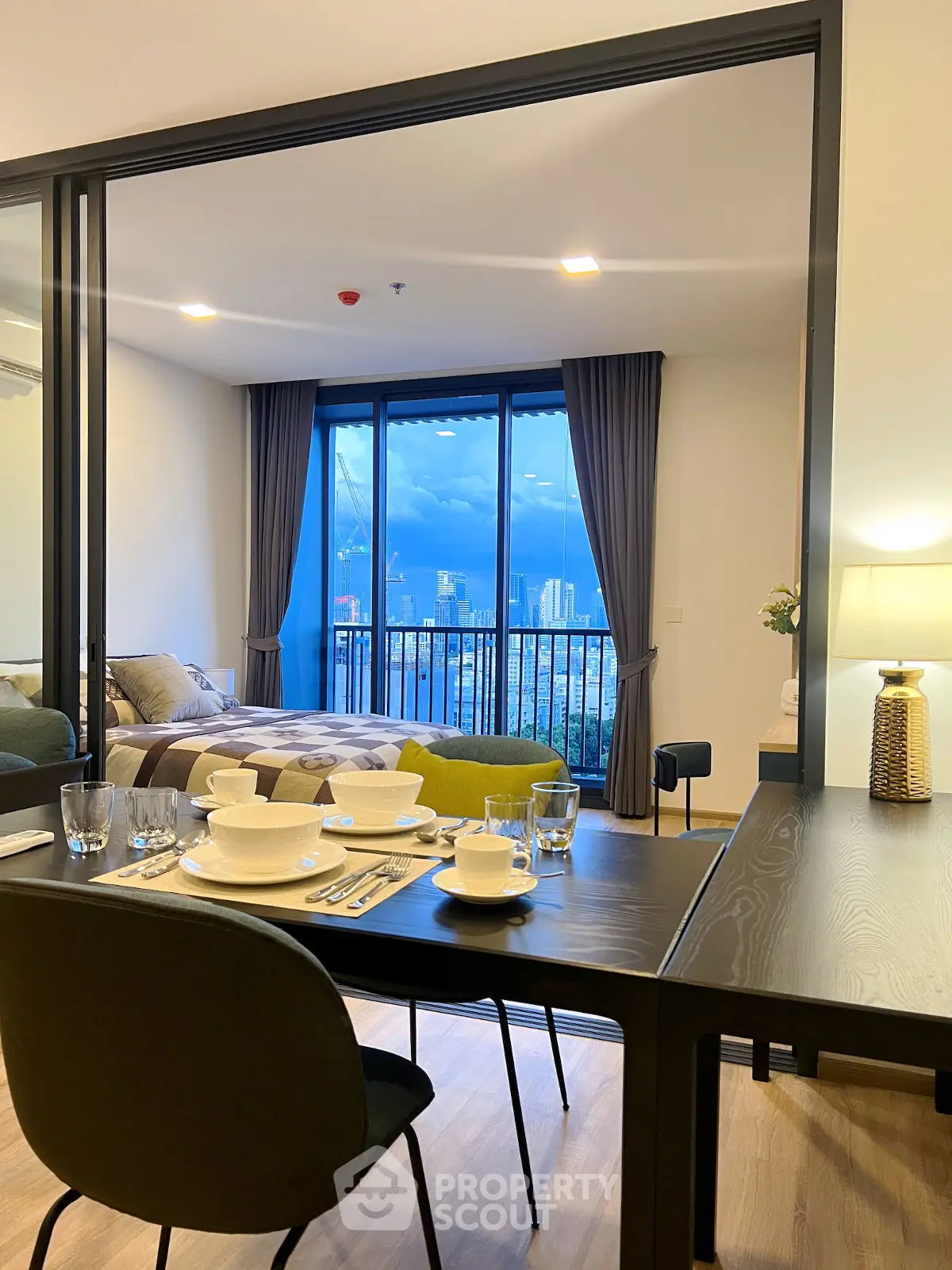 Modern apartment with dining area and stunning city view from balcony