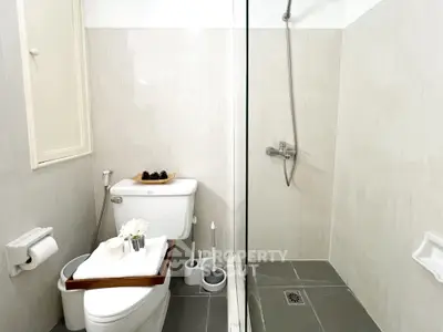 Modern bathroom with sleek shower and elegant decor, perfect for a contemporary home.